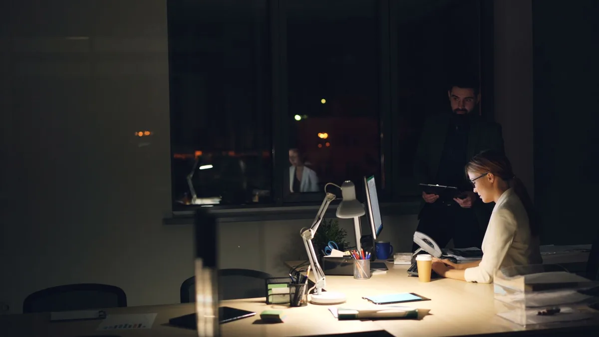Business owner working late at the office - the admin burden is the real price of a self-hosted CRM