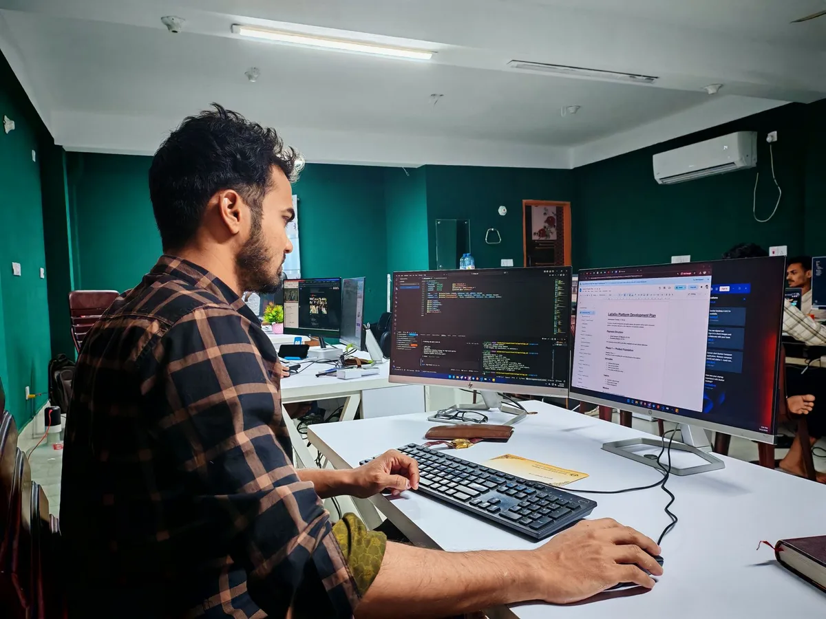 Developer working across two monitors - custom Perfex module development when the catalogue doesn't fit