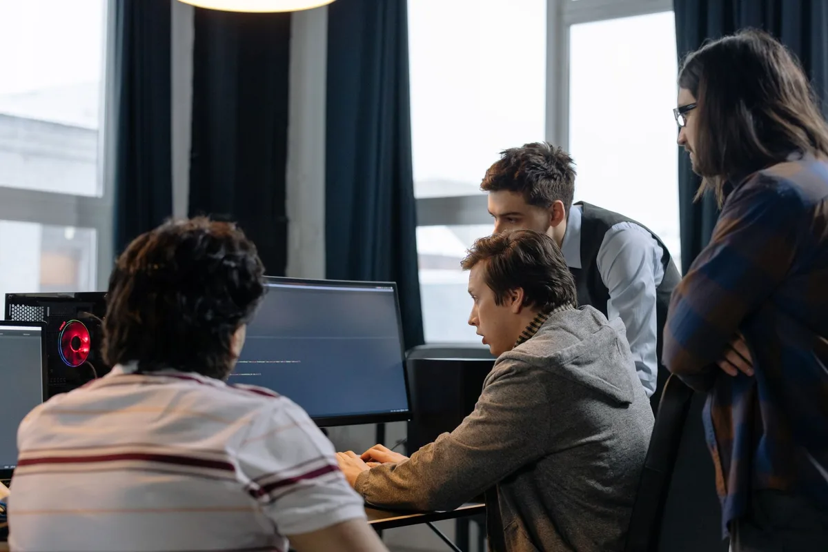 A development team pairing on code - team composition is the biggest driver of web app development cost
