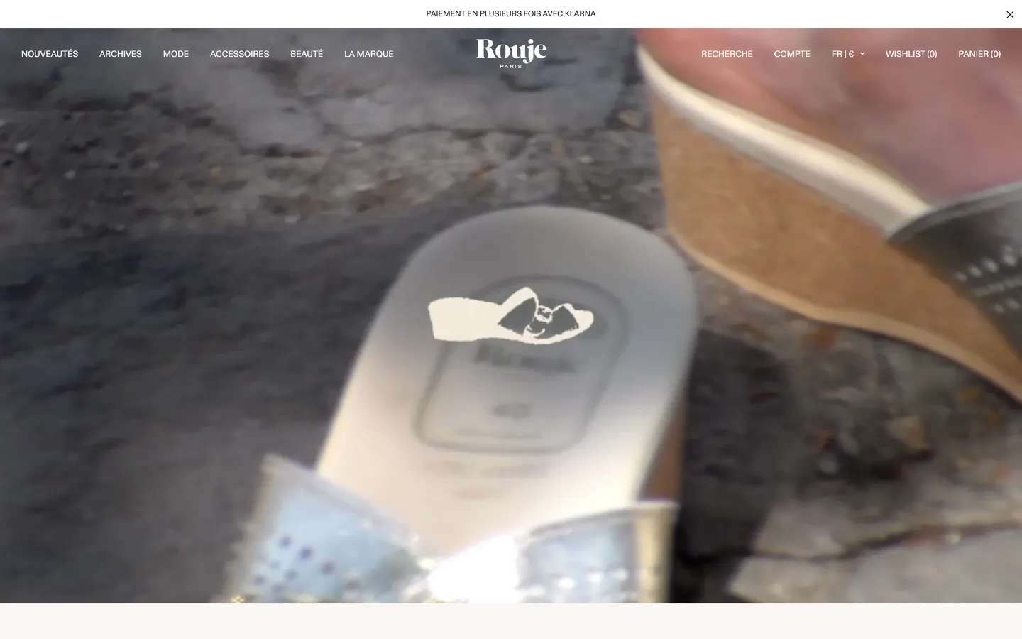 The top of the Rouje.com homepage: the Rouje Paris wordmark navigation over a full-screen lifestyle film